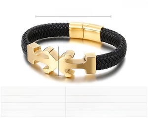 Macro detail of nautical anchor clasp in gold finish with black braided leather strap