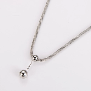 Detailed shot of silver stainless steel ball pendant with mesh chain necklace