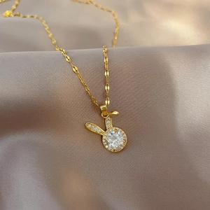 Cute bunny necklace in gold finish with crown and sparkling zircon on satin fabric
