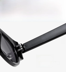 Detailed macro view of the fixed combination hinge on these black cat-eye sunglasses
