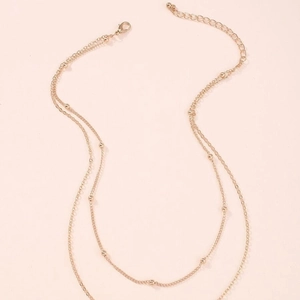 Double-layered gold snake chain necklace with small beads and lobster clasp closure