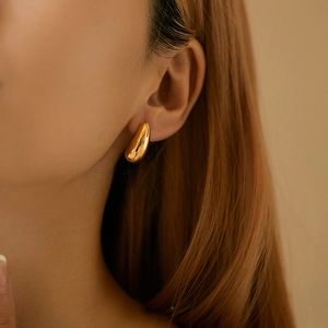 Polished gold teardrop stud earrings for women with minimalist geometric C-shape design