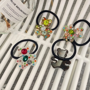 Détail macro d'élastiques à cheveux ours en résine avec strass colorés en quatre tons