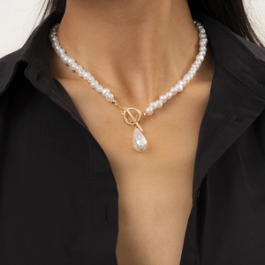 Close-up of elegant baroque pearl necklace with golden OT toggle clasp and pearl drop