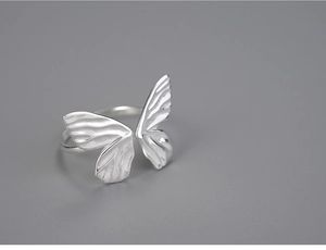 Close-up of polished S925 sterling silver butterfly ring with intricate metallic details