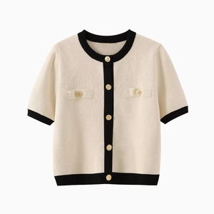 Elegant white short-sleeved knit cardigan with black contrast trim and gold buttons