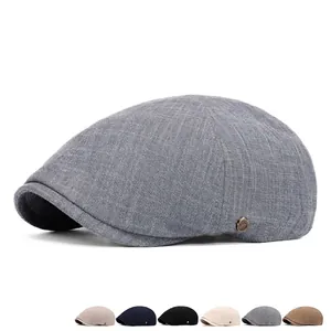 Men's newsboy cap in grey textured fabric with metal logo and multi-color options