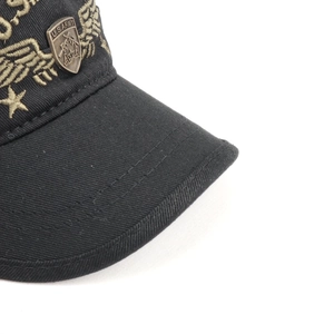 Detail of gold eagle embroidery and U.S. ARMY metal shield badge on tactical black cap