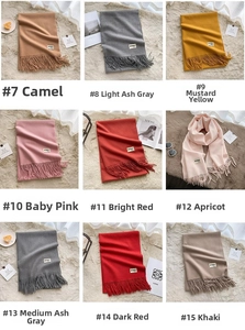 Detail grid showing various solid color pashmina scarves with tassels on soft background