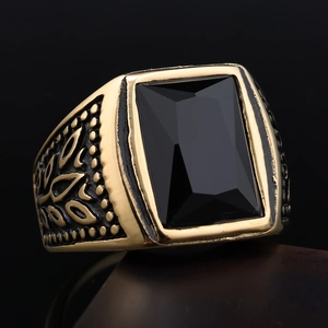 Close-up of vintage stainless steel ring with black rectangular stone and embossed leaves