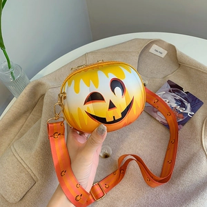 Detail of Halloween pumpkin crossbody bag with smile face and striped shoulder strap