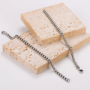 Minimalist 304 stainless steel 5mm box chain bracelets displayed on beige stone