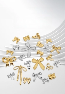 Assorted bow-shaped metal jewelry pendants in gold and silver for DIY craft necklace