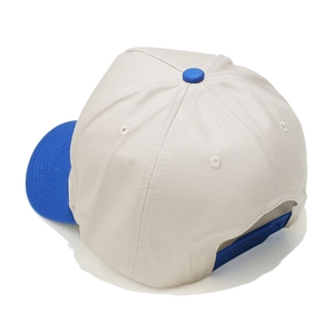 Detail view of the two-tone baseball cap with adjustable blue plastic snapback closure