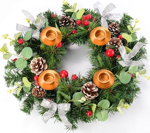 Detailed top view of a green Christmas wreath with 4 gold candle holders and red berries