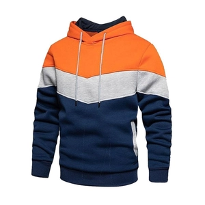 Detail view of tri-color patchwork hoodie with orange, grey and navy blue panels
