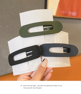 Three matte finish minimalist duckbill hair clips in olive, black and navy blue