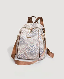 Close-up of vintage wave pattern on canvas backpack with elegant gold-tone zippers