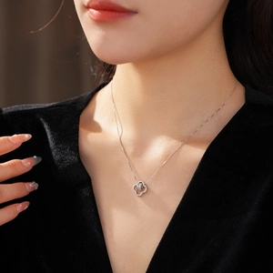 Close-up of a silver floral necklace with sparkling zircons on a model's neck