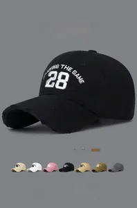 Detail of embroidered number 28 baseball cap showing vintage distressed brim and 7 colors