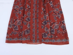 Detail of floral print maxi dress featuring ethnic patterns and black button down front