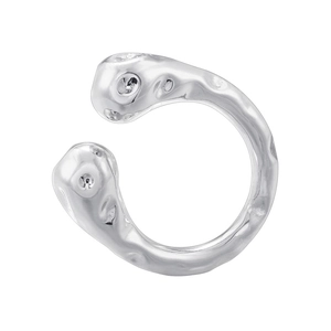 Detailed view of silver ear cuff featuring irregular lava texture and open-ended design