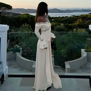 Elegant white V-neck maxi dress with lace stitching, ruffle sleeves and side slit detail