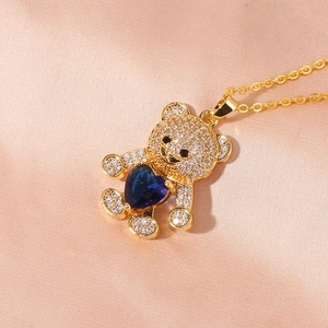 Gold plated bear pendant necklace with blue heart stone and white cubic zirconia crystals