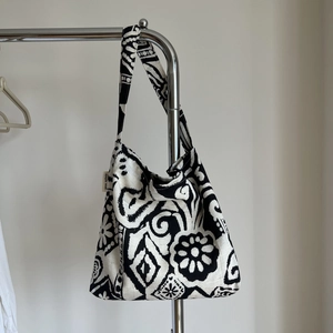 Detail of bohemian printed linen bag with side fabric label on white background