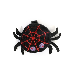 Macro detail of plush Halloween spider hair clip with red web and purple eye embroidery