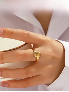 Polished gold teardrop open ring styled on finger with elegant lifestyle background