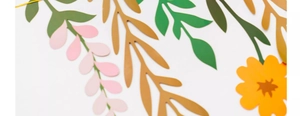 Close-up of colorful paper floral banners with pink and green leaves for wall decoration