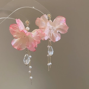 Detail of pink fabric flower earrings with pearl tassels and crystal water drop pendants
