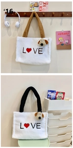 Detail of plush tote bag with LOVE embroidery and cute puppy charm in white and brown