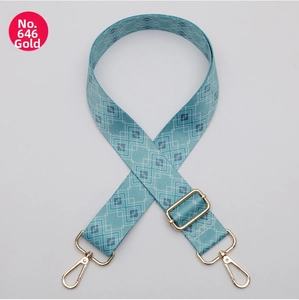 Detail of adjustable 38mm teal wide strap with white geometric patterns and gold lobster hooks