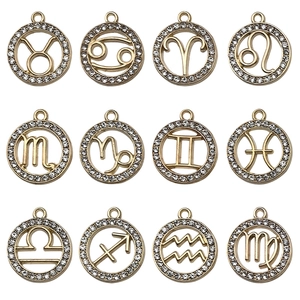 Set of 12 gold plated zodiac pendants featuring sparkling rhinestones in a grid layout