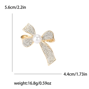 Elegant gold bow brooch with white pearls and rhinestones showing 5.6cm height dimensions
