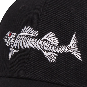 Macro shot of 3D fishbone embroidery on black twill cotton baseball cap with red details