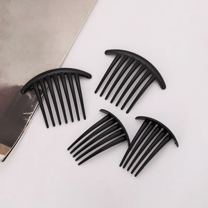 Set of four black plastic fashion hair combs for women shown on a white background