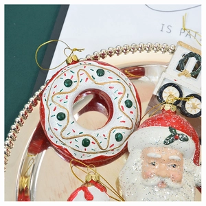 Macro detail of glittery Christmas donut and Santa ornaments on a golden tray