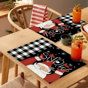 Detail of Christmas placemats with buffalo plaid and JOY text on wooden dining table