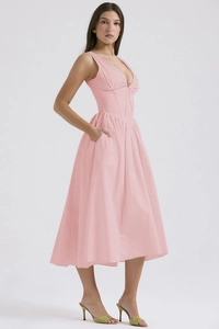 Detail view of pink V-neck midi dress featuring side pockets and high-waisted pleats