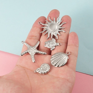 Silver ocean pendants set including sun, starfish, sea turtle and seashell charms