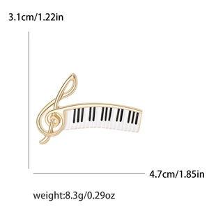 Detail view of treble clef and piano keyboard brooch with dimensions 3.1cm x 4.7cm