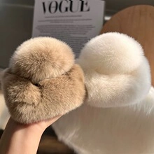 Detail of plush faux fur winter hats in beige and light khaki colors for women