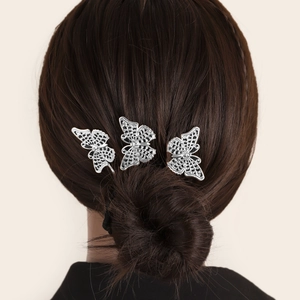 Three-piece silver hollow butterfly hairpins worn on elegant updo hairstyle