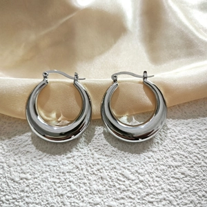 Macro detail of high-quality polished silver hoop earrings with secure clasp mechanism