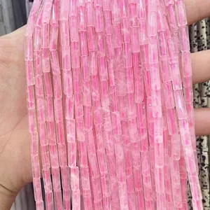 Detailed view of pink rose quartz cylinder tube beads with natural ice cracks for DIY jewelry
