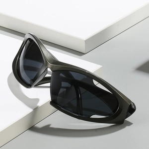 Futuristic silver Y2K sports sunglasses with grey lenses on geometric podium
