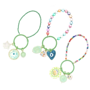 Detail of colorful beaded evil eye keychains with crystal hearts and metal charms